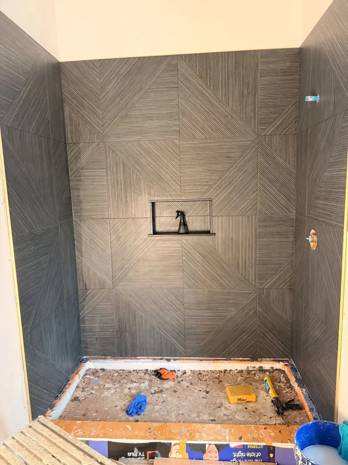 Geometric tile detailing and a carefully aligned niche. Work in progress.