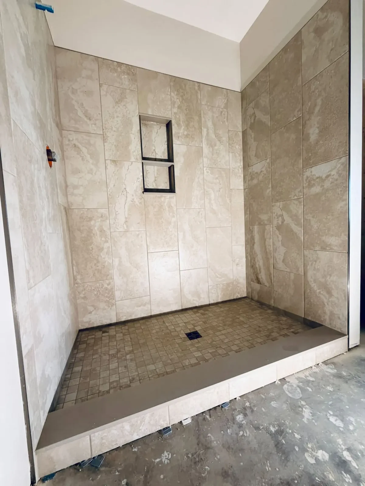 A closer look at tile alignment, niche detailing and the shower threshold.